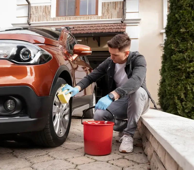 Lavage auto à domicile Rang : professionnel intervenant sur un véhicule